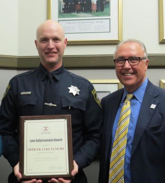 President Umberto S. Davi (right) presented an ISBA Law Enforcement Award to Glen Ellyn Police Officer Luke Elmore on Oct. 26. 