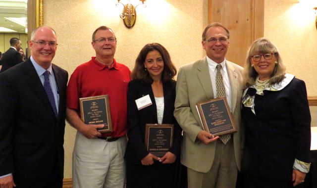 ISBA Past President John E. Thies (left) and ISBA President Paula H. Holderman (right) present McAndrews Awards to (from left) Michael McElvain, McDonald's Corp. and the Clark County Bar Association.