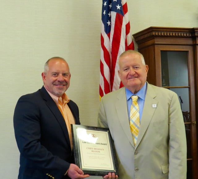 ISBA President-elect Hon. Russell W. Hartigan (right) presents a 2016 ISBA Law Enforcement Award to retired Hinsdale Police Chief Bradley Bloom on July 22 at the Village Hall of Hinsdale.