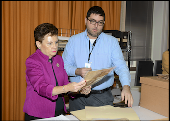 Justice Rita Garman with Archives’ conservator Alex Dixon examine a restored oath.