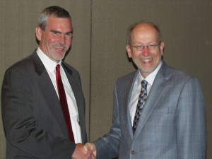 Mark Mathewson, ISBA Director of Publications, is congratuled by outgoing NABE President Rod Wegener