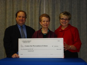 IBF Board Member Richard Zuckerman of Peoria presents a $5,000 grant to Martha Herm, Executive Director of the Center For Prevention of Abuse and Nancy Wright, President of its Board of Directors.
