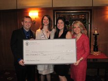 Student leaders of the Joseph Story Law School Chapter at DePaul University College of Law present a check for $2,000 benefiting the Chicago Metropolitan Battered Women's Network from proceeds from their annual fundraiser.  From L to R:  Ryan Schermerhorn, Co-Justice of Story Chapter; Dawn Dalton, Executive Director of the Network; Lauren Chibe, Co-Justice of Story Chapter; Michele Jochner, Justice of the Chicago Alumni Chapter and Board Member of the Network.  